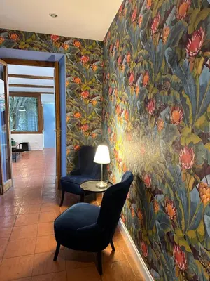 a living room with a flower mural on the wall at The Vatican Jungle loft con giardino vicino al Vaticano in Rome