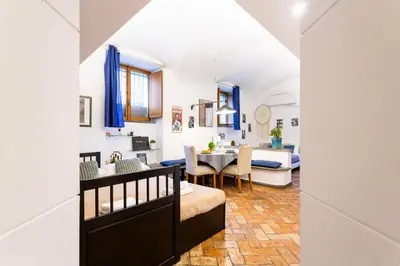 a living room and dining room with a dining table at BBB House in Rome