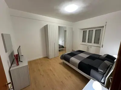 a bedroom with a black and white bed in a room at CASA DEL SOLE in Rome