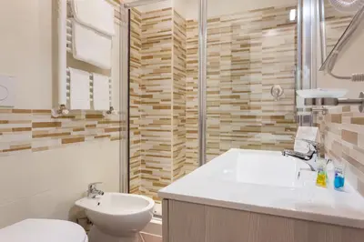 a bathroom with a sink and a toilet and a shower at B&B Sol Romae in Rome