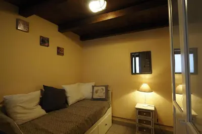 a room with a bed with a lamp and a window at Loft Germanico in Rome