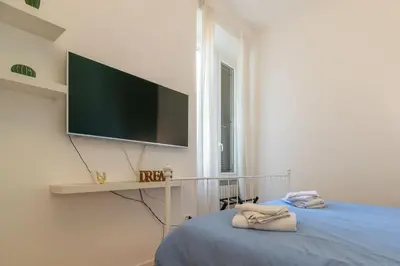 a bedroom with a flat screen tv on a wall at CasaLu San Pietro in Rome