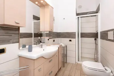 a bathroom with a sink and a toilet at Stunning Center Rome Apartment in Rome