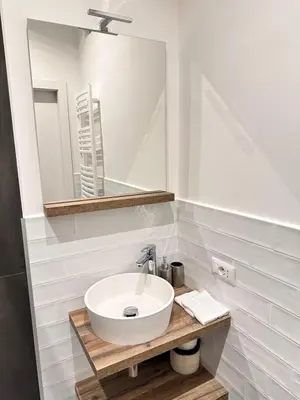 a bathroom with a white sink and a mirror at St. Peter's Balloon a due passi da San Pietro! in Rome