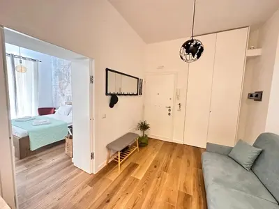 a living room with a couch and a bedroom at St. Peter's Balloon a due passi da San Pietro! in Rome
