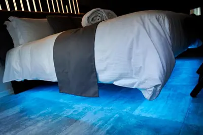 a bed with white sheets and a tie on it at HeySuite - Luxury House - ROMA Trastevere in Rome