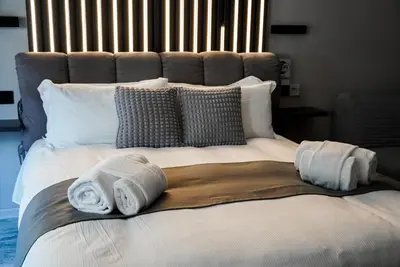 a large bed with two towels on top of it at HeySuite - Luxury House - ROMA Trastevere in Rome