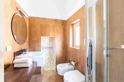 a bathroom with a sink and a toilet and a mirror at Balestrari Boutique Apartment in Rome