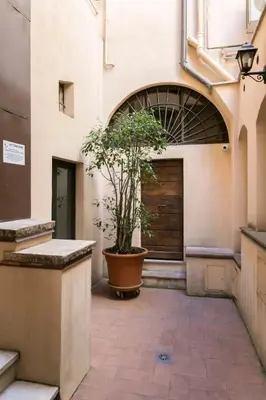 a potted tree in a pot in a building at Balestrari Boutique Apartment in Rome