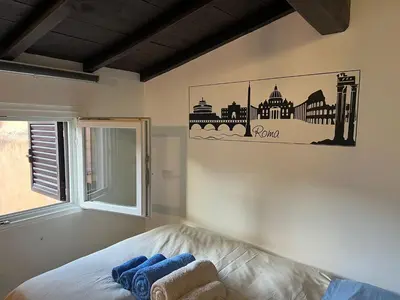 a bedroom with a bed with blue towels on it at Monolocale Trastevere locato per finalità turistiche in Rome
