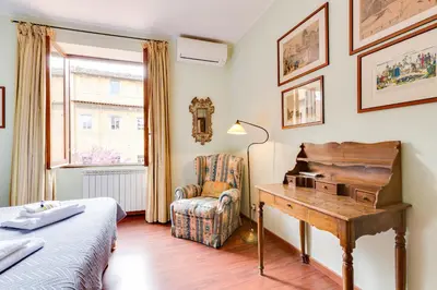 a bedroom with a desk and a chair and a bed at Rome as you feel - Luxury Cappellari Apartment in Rome