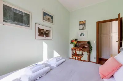 a bedroom with a bed and a table and a chair at Rome as you feel - Luxury Cappellari Apartment in Rome