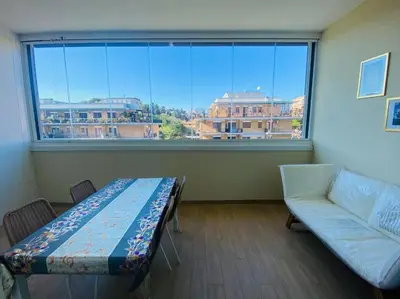 a living room with a couch and a large window at Mini appartamento vicino Trastevere in Rome