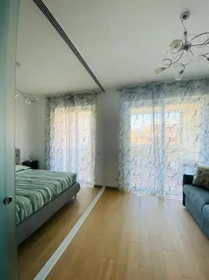 a bedroom with a bed and a couch in it at Mini appartamento vicino Trastevere in Rome