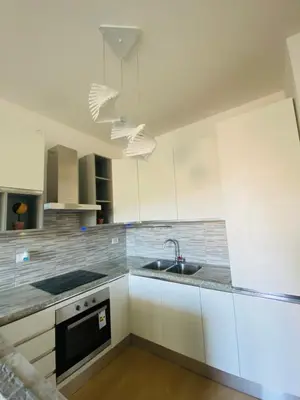 a kitchen with white cabinets and a sink at Mini appartamento vicino Trastevere in Rome