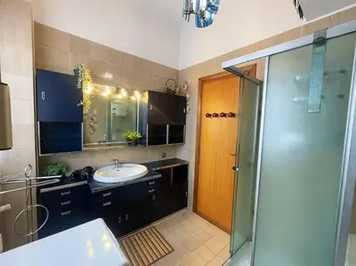 a bathroom with a sink and a shower and a mirror at Da Bricca a Monteverde in Rome