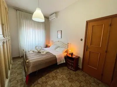 a bedroom with a bed with two candles on it at Da Bricca a Monteverde in Rome