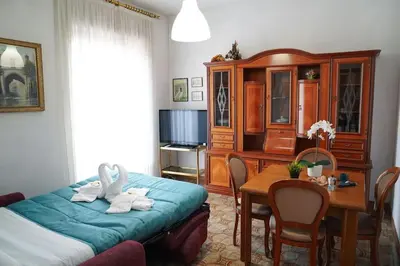 a bedroom with a bed and a dining room table at Da Bricca a Monteverde in Rome