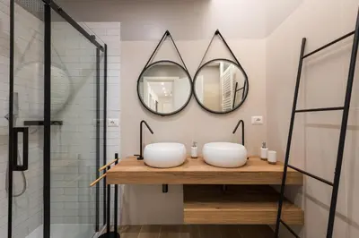 a bathroom with two sinks and two mirrors at Super Comfort Pisino Street in Rome