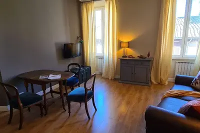 a living room with a table and chairs and a couch at CAMERA con VISTA in Rome