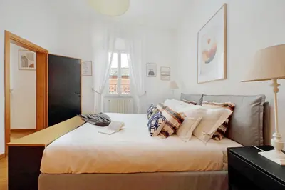 a bedroom with a bed with pillows and a window at Metastasio in Rome