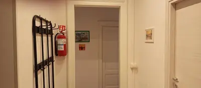 a fire extinguisher hanging on the wall of a hallway at Rome Near Colosseum in Rome