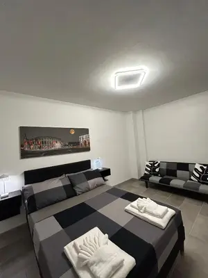 a bedroom with a large bed and a couch at La Terrazza di Attila in Rome