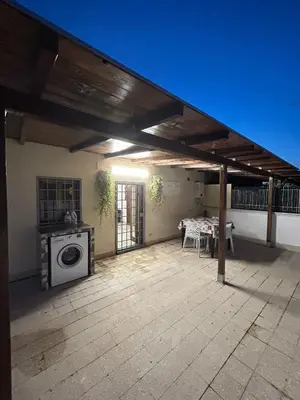 a patio with a washer and dryer on a house at La Terrazza di Attila in Rome