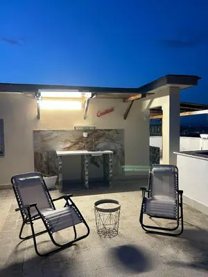 two chairs and a table on a patio at La Terrazza di Attila in Rome
