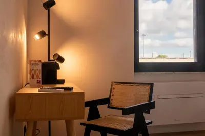 a room with a desk and a chair and a window at Cunabu Apartments in Rome