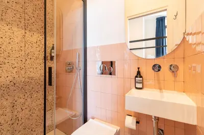 a bathroom with a toilet and a sink and a mirror at Cunabu Apartments in Rome