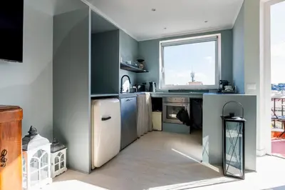 a kitchen with a refrigerator and a window at LA VUE DE PAULINE in Rome