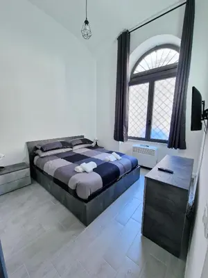 a bedroom with a large bed and a window at DOMVS Ginori Testaccio in Rome