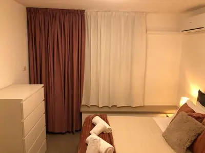 a bedroom with a bed and a dresser and a window at MON CHERI COLOSSEO in Rome