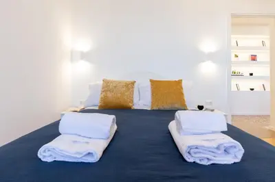 a large bed with towels on top of it at Adventura Penthouse in Rome