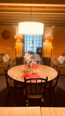 a dining room table with a vase of flowers on it at Apartamento loft ingresso independente central zona san lorenzo in Rome