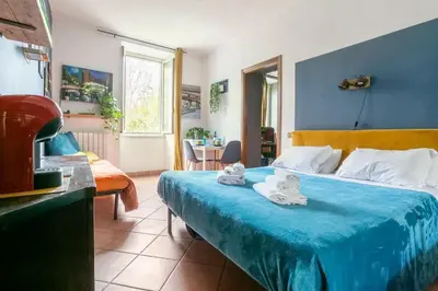 a bedroom with a bed with towels on it at Guest Art Trastevere Station with AC in Rome