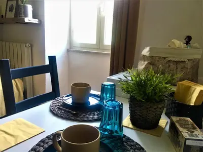 a table with two blue glass bottles and cups on it at Guest Art Trastevere Station with AC in Rome