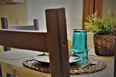 a table with two plates and a blue glass at Guest Art Trastevere Station with AC in Rome