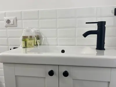 a bathroom sink with a black faucet at Testaccio Industrial Loft in Rome