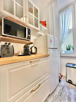 a kitchen with a microwave and a refrigerator at Vacanze Romane Colosseum in Rome