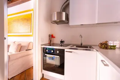 a kitchen with a sink and a stove at FIORE home Rome Center Campo dè Fiori in Rome