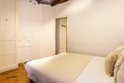 a white bedroom with a bed and a closet at FIORE home Rome Center Campo dè Fiori in Rome