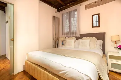a bedroom with a large bed and a window at FIORE home Rome Center Campo dè Fiori in Rome