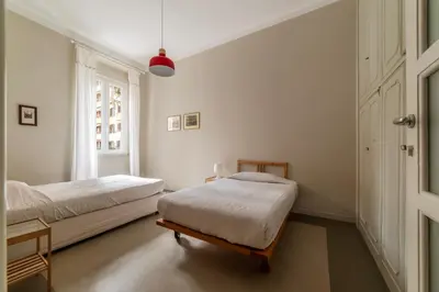 a bedroom with two beds and a window at GuestHost - Piazza Bainsizza Elegant Apartment in Rome