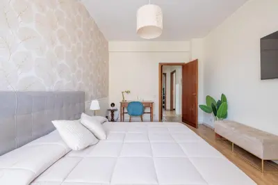 a living room with a white couch and a table at Vista Indimenticabile sulla Cupola di S. Pietro in Rome
