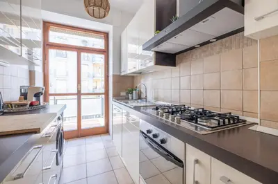 a large kitchen with a stove and a window at Vista Indimenticabile sulla Cupola di S. Pietro in Rome