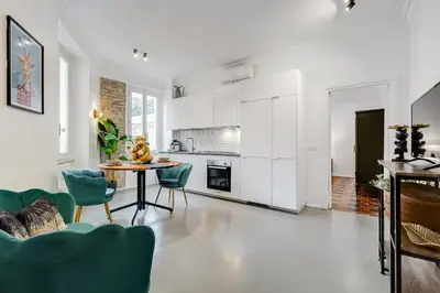 a kitchen and dining room with a table and chairs at Klioos Apartment Testaccio in Rome