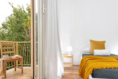 a bedroom with a bed and a balcony at SkyView Home in Rome