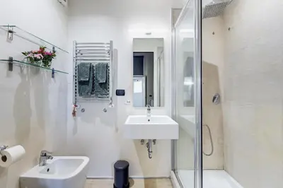 a white bathroom with a sink and a shower at Roma Coronari a 2 minuti da piazza Navona in Rome